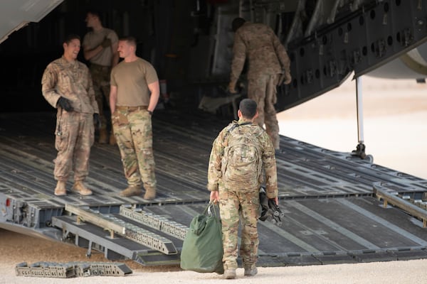 In this Oct. 24 photo, released by the U.S. Army Reserve, service members board a cargo plane to leave Syria at the Kobani Landing Zone, Syria. Pivoting from the dramatic killing of the Islamic State group's leader, the Pentagon is increasing U.S. efforts to protect Syria's oil fields from the extremist group as well as from Syria itself and the country's Russian allies. It's a new high-stakes mission even as American troops are withdrawn from other parts of the country.