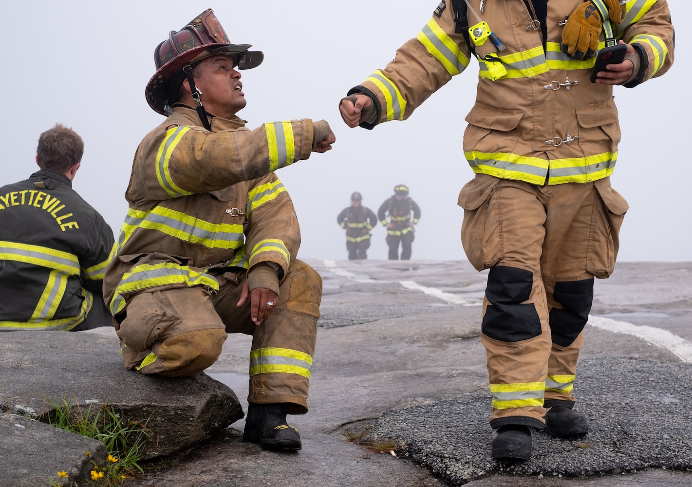 DeKalb County Cpt. Jovan Carter, left, gets a fist bump after climbing Stone Mountain on Sunday morning, Sept. 11, 2022, during the annual remembrance of the 9/11 terrorist attacks. (Photo: Ben Gray for The Atlanta Journal-Constitution)