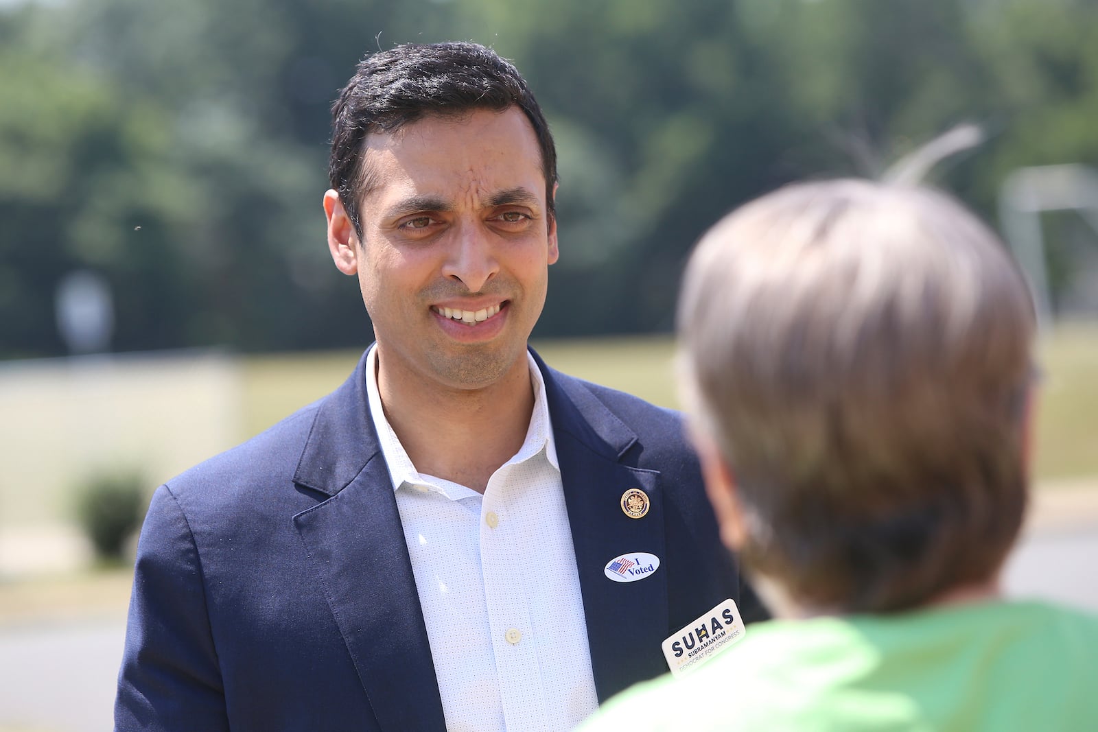 Virginia Sen. Suhas Subramanyam, a Democrat running for Virginia's 10th House seat, talks with voters outside the Harper Park Middle School polling station at in Leesburg, Va., June 18, 2024. (Mark Miller/The Washington Post via AP)