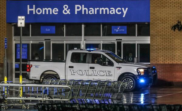 A Peachtree City police vehicle is parked outside the Walmart Supercenter on Ga. 54, where a fire raged for hours Wednesday night. Police are asking anyone who saw "suspicious behavior" before the fire started to come forward.