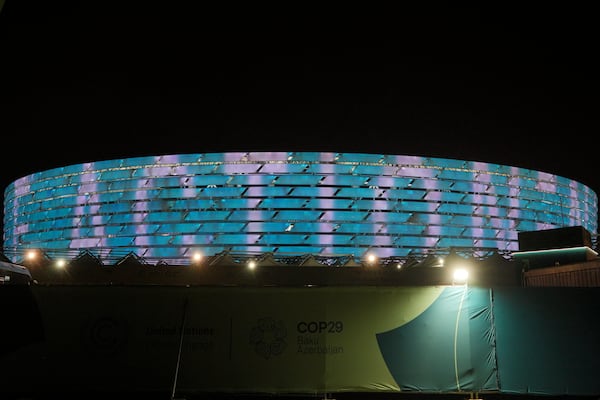 The Baku Olympic Stadium, the venue for the the COP29 U.N. Climate Summit, is illuminated on Monday, Nov. 11, 2024, in Baku, Azerbaijan. (AP Photo/Peter Dejong)