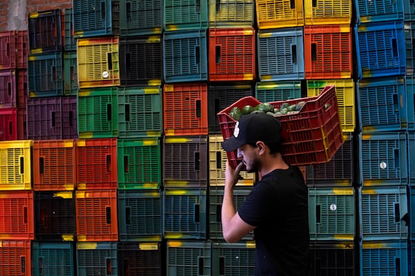 FILE - A worker carries a crate of avocados at a plant in Uruapan, Michoacan state, Mexico, Feb. 9, 2024. (AP Photo/Armando Solis, File)