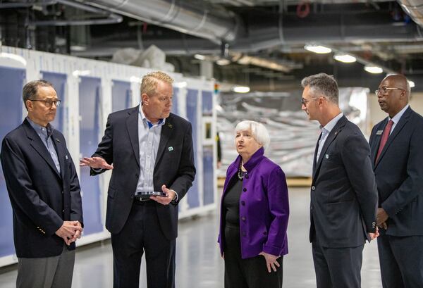  U.S. Treasury Secretary Janet Yellen (center) will be in Atlanta today. She is pictured touring a solar cell manufacturing facility in Norcross in March. 