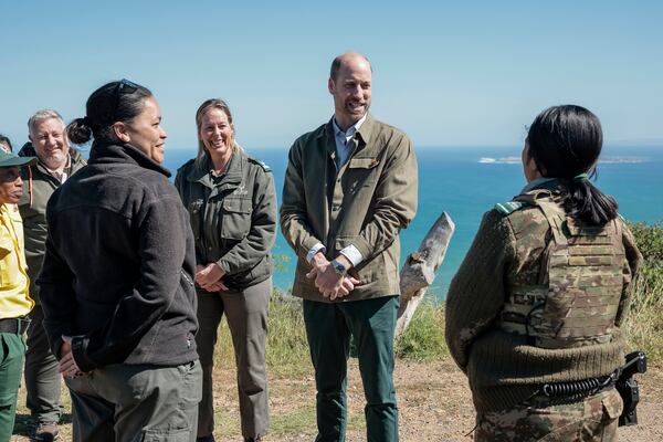 Britain's Prince William, 2nd right, meets with Park Manager for Table Mountain National Park Megan Taplin, third right, and other rangers while visiting Signal Hill in Cape Town, South Africa, Tuesday, Nov. 5, 2024. (Gianluigi Guercia/Pool via AP)