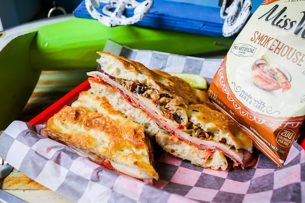 Motorboat's muffuletta breaks with tradition by using focaccia instead of round Sicilian sesame bread. The handheld also is pressed instead of standing a mile high. (Courtesy of Praim Siribothi)