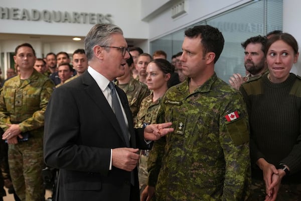 Britain's Prime Minister Keir Starmer speaks to a Canadian Lt Colonel as he visits a military base to meet planners mapping out next steps in the Coalition of the Willing in Northwood, London, Thursday, March 20, 2025.(AP Photo/Alastair Grant, Pool)