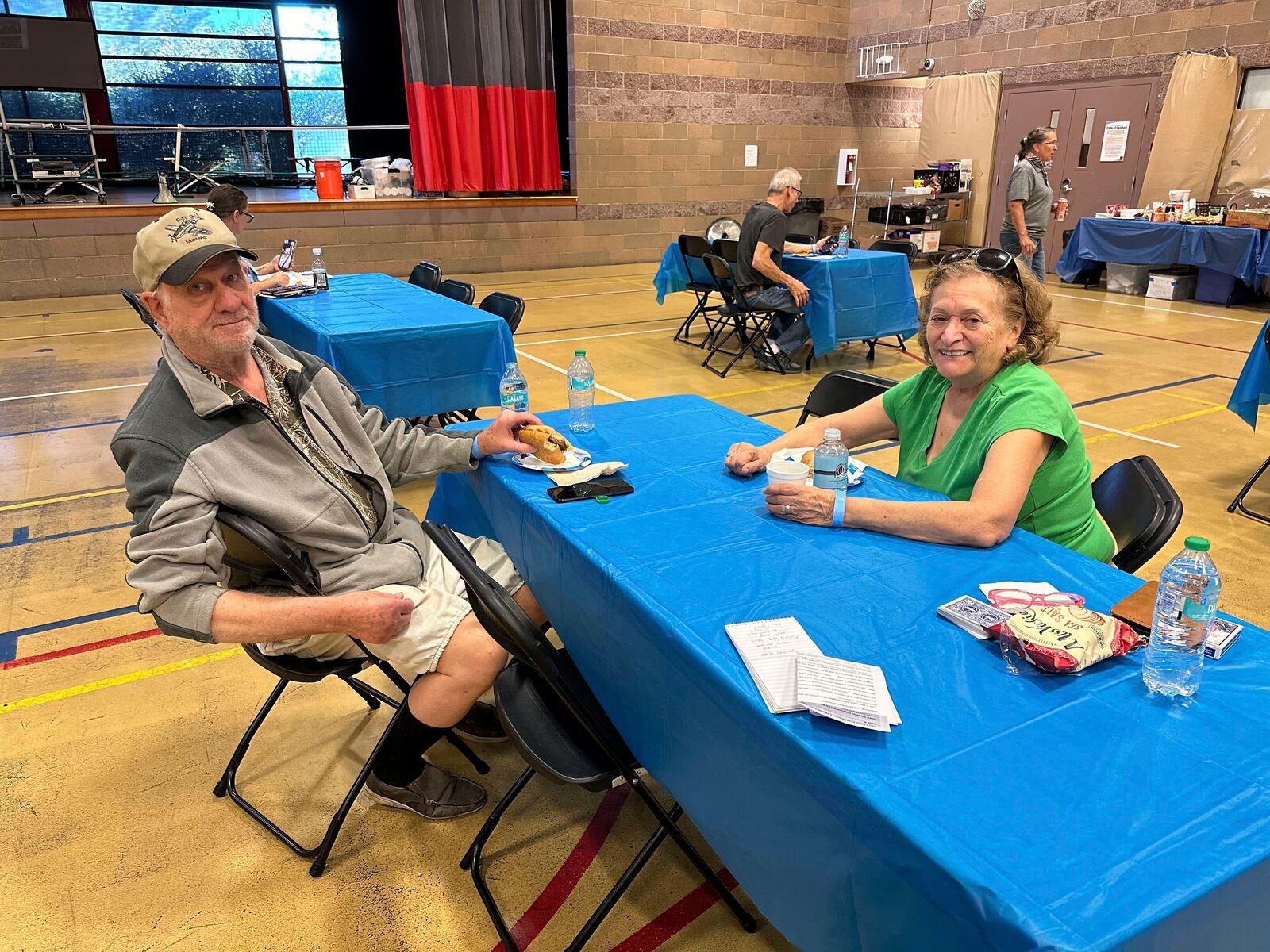 Rich Meyr, 82, left, and Evelyn Kelley, 77, sit at an evacuation center for those in the path of regional wildfires, Wednesday, Sept. 11, 2024, in Reno, Nevada. The two were the first — and so far only - arrivals at a new evacuation center set up Wednesday at a recreation center in south Reno where the Red Cross was prepared to handle 100 or more people if necessary. (AP Photo/Scott Sonner)