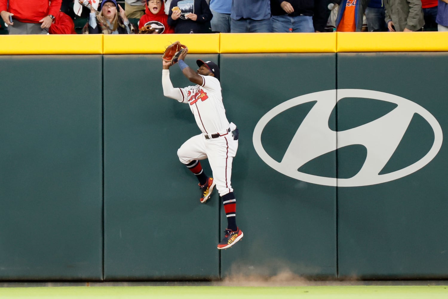 Atlanta Braves center fielder Michael Harris II (23) jumps against the fence to catch the ball during the second inning at Truist Park on Saturday, Oct. 1, 2022. Miguel Martinez / miguel.martinezjimenez@ajc.com