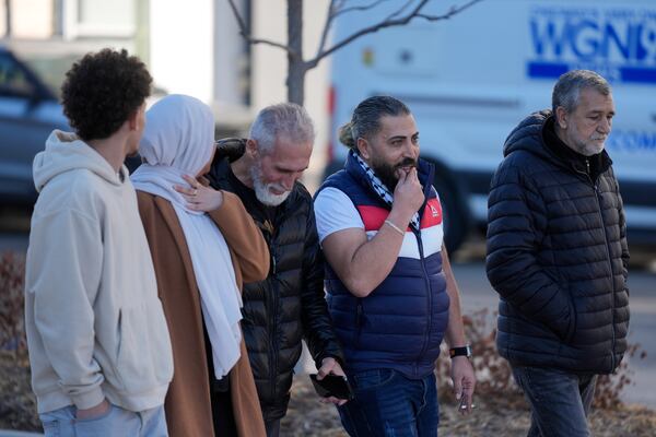 Odai Alfayoumi, second from right, father of six-year-old Palestinian boy Wadee Alfayoumi, leaves Will County Courthouse with others where Joseph Czuba, 73, is charged with and on trial in the fatal stabbing of the boy and the wounding of his mother Hanan Shaheen, Tuesday, Feb. 25, 2025, in Joliet, Ill. (AP Photo/Erin Hooley)