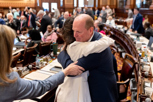 State Rep. Holt Persinger (right), a Republican from Winder, is congratulated by Rep. Kimberly New, a Republican from Villa Rica, following the passage of the school safety bill he sponsored at the Capitol in Atlanta on Tuesday.