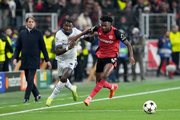 Inter Milan's Marcus Thuram vies for the ball with Leverkusen's Edmond Tapsoba (right) during the Champions League opening match between Bayer Leverkusen and Inter Milan at the BayArena in Leverkusen, Germany, on Tuesday, December 10, 2024. (AP Photo /Martin Meissner)