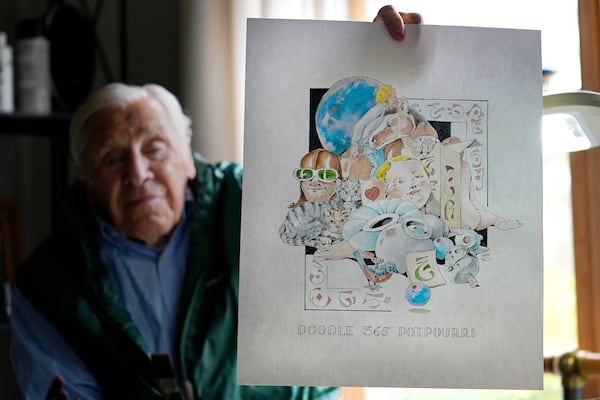 FILE - Artist Robert Seaman holds up the 365th daily doodle sketch in his room at an assisted living facility Monday, May 10, 2021, in Westmoreland, N.H. (AP Photo/Charles Krupa, File)