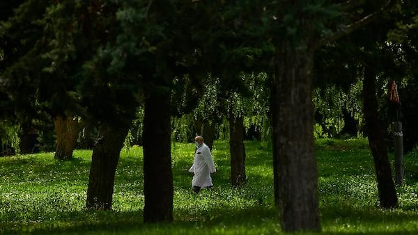 A member of the health service at Txagorritxu hospital walks along the perimeter of the hospital, in Vitoria, northern Spain, Vitoria, northern Spain, March 20, 2020. (AP Photo/Alvaro Barrientos)