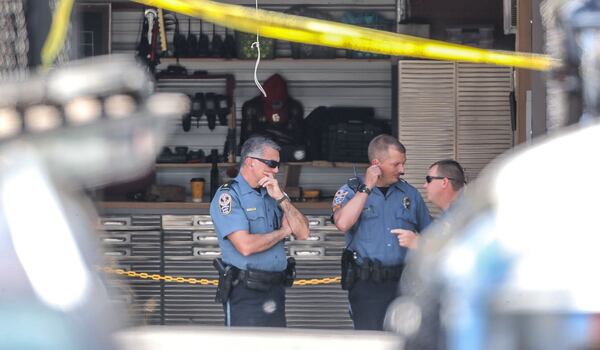 The victim was found dead behind a used car dealership on Stone Mountain Highway near Lilburn. 