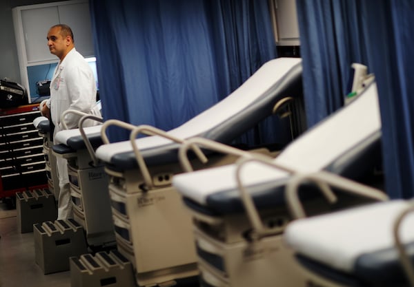 Dr. Hany Atallah stands inside a mobile emergency room set up outside Grady Memorial Hospital to help handle the ever-growing number of flu cases in Atlanta, Monday, Jan. 29, 2018. (AP Photo/David Goldman)