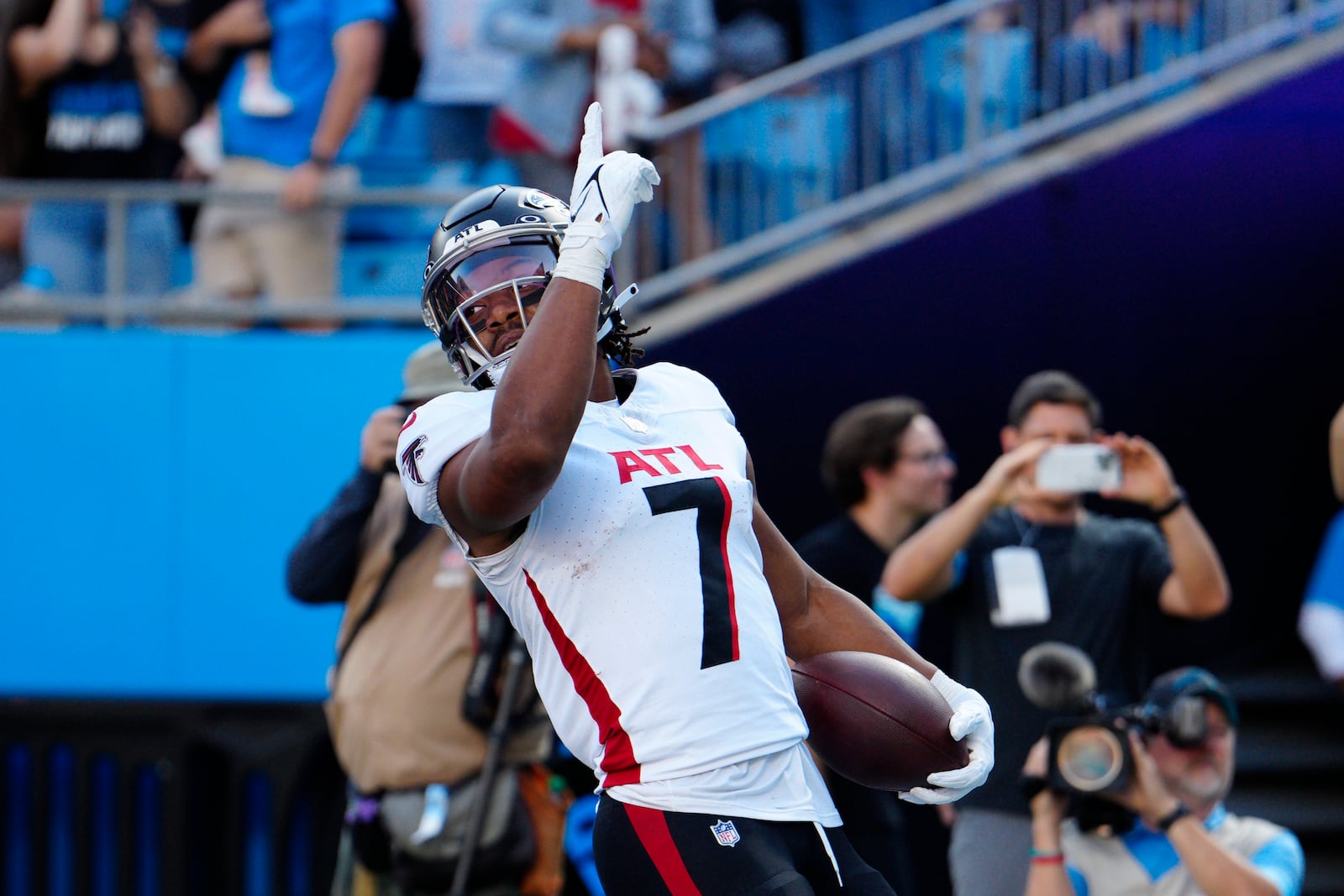 Atlanta Falcons running back Bijan Robinson (7) celebrates after running in a touchdown in the first half of an NFL football game against the Carolina Panthers in Charlotte, N.C., Sunday, Oct. 13, 2024. (AP Photo/Jacob Kupferman)