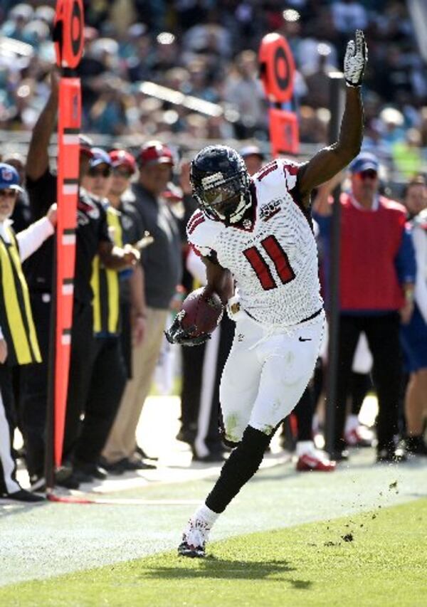 Atlanta Falcons wide receiver Julio Jones tries to stay in bounds after a reception against the Jacksonville Jaguars during the first half of an NFL football game in Jacksonville, Fla., Sunday, Dec. 20, 2015. (AP Photo/Phelan M. Ebenhack)