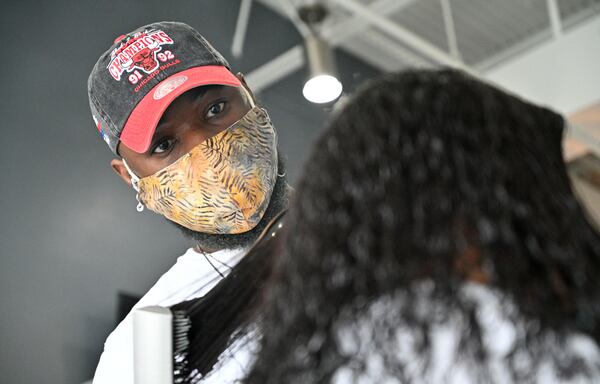 Brandon Newton, hairstylist, styles a customer's hair at Blo Blow Dry Bar in Buckhead on Tuesday, January 26, 2021. The pandemic has been hard on small businesses and hard on companies that rely on in-person transactions - and hardest on those that are both. (Hyosub Shin / Hyosub.Shin@ajc.com)