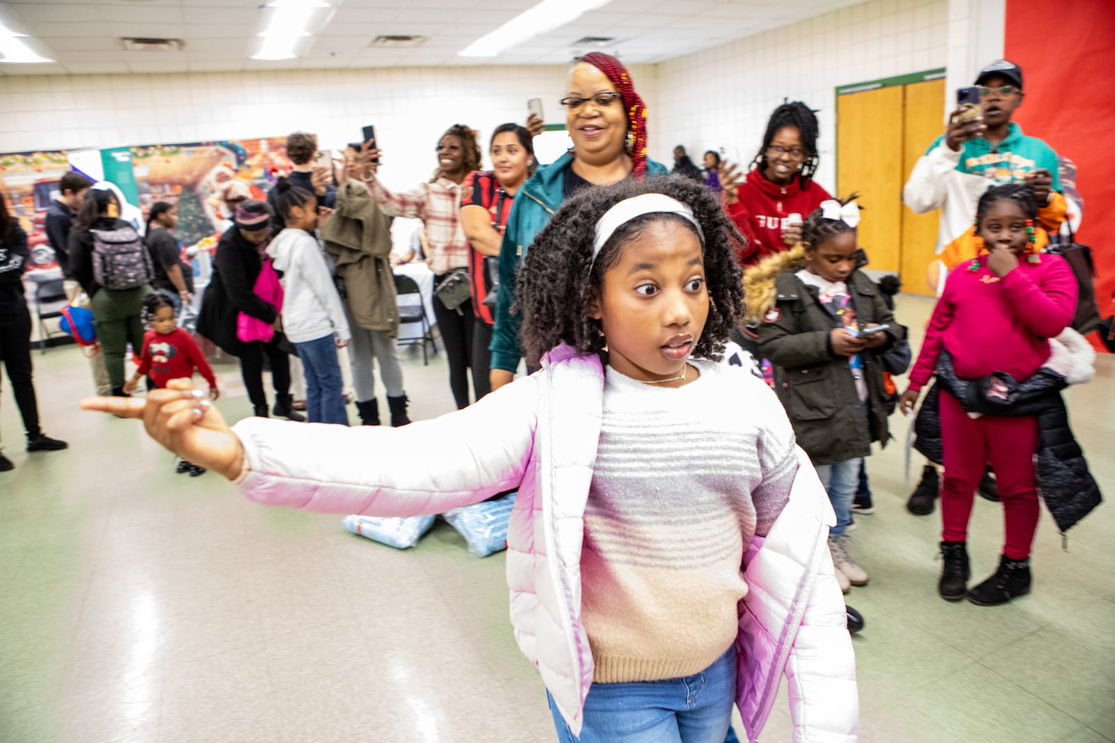 Angel Wilson, 10, reacts when Shaquille O’Neal comes into the room during Thursday's gathering.