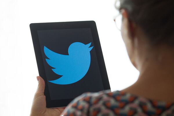 A person is seen using the Twitter app on a tablet. (Photo by Jaap Arriens/NurPhoto via Getty Images)