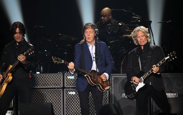 Oct. 15, 2014 ATLANTA: The legendary Sir Paul McCartney jamming with two of his guitarist at the Philips Arena in Atlanta Wednesday. (Akili-Casundria Ramsess/Special to the AJC) Guitarists Rusty Anderson (left) and Brian Ray and drummer Abe Laboriel allow McCartney plenty of musical freedom. Photo: Akili-Casundria Ramsess/Special to the AJC