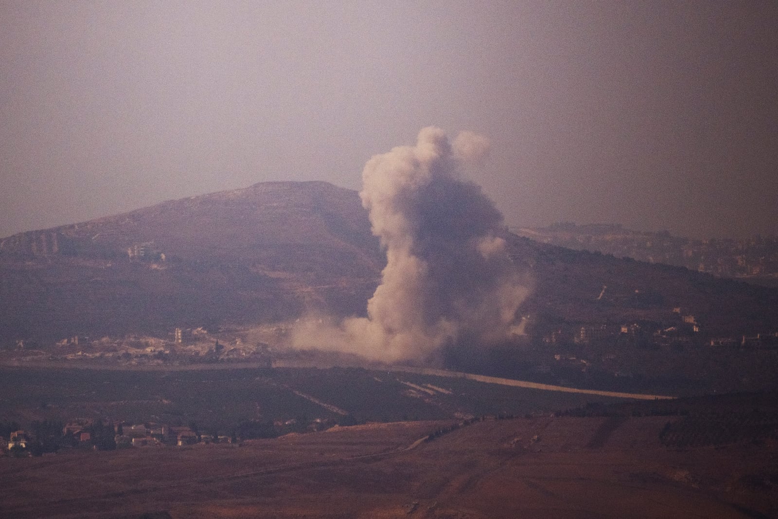 Smoke rises following an explosion in southern Lebanon as seen from northern Israel, Wednesday, Oct. 16, 2024. (AP Photo/Leo Correa)