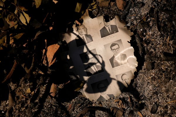 A partially burned yearbook is seen on the ground in the aftermath of the Palisades Fire in the Pacific Palisades neighborhood of Los Angeles, Monday, Jan. 13, 2025. (AP Photo/John Locher)