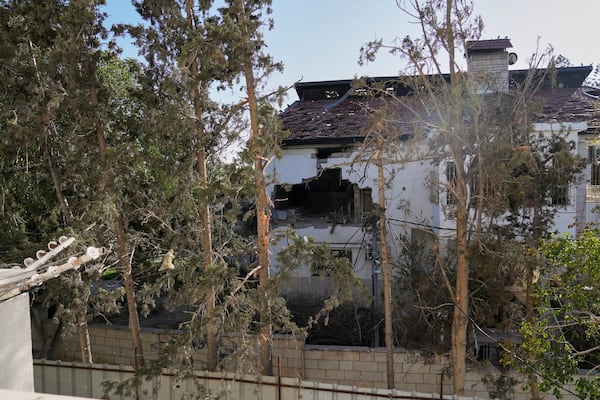 The impact of a projectile is visible on the wall of the U.N. guesthouse, where United Nations workers were located when the building was struck, leaving one staff member dead and five others injured in Deir al-Balah, central Gaza, Wednesday, March 19, 2025. (AP Photo/Abdel Kareem Hana)