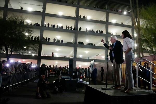 Sen. Bernie Sanders, I-Vt., and Rep. Alexandria Ocasio-Cortez, D-N.Y., speak outside of Arizona State University to the overflow crowd that did not get inside the arena, during a "Fighting Oligarchy" tour event Thursday, March 20, 2025, in Tempe, Ariz. (AP Photo/Ross D. Franklin)