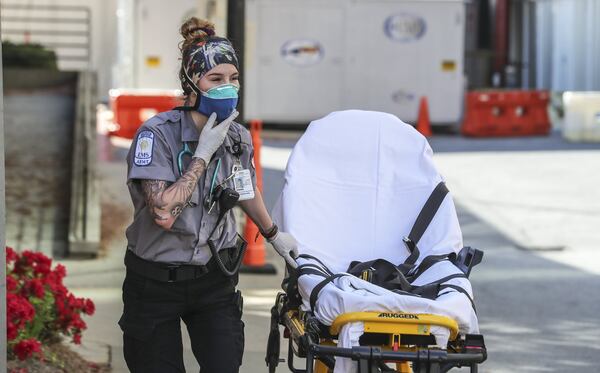 Grady Advanced EMT, Emma Hovis prepares for another patient call. First responders at Grady Hospital are on the frontline of the COVID-19 epidemic and are taking precautions on each call. JOHN SPINK/JSPINK@AJC.COM