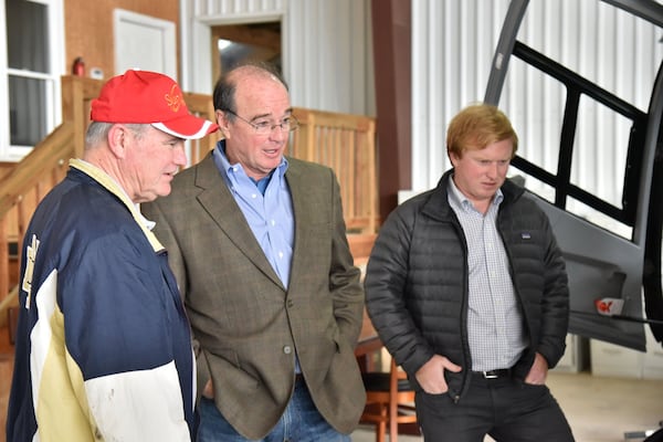 Toland (center) talks to customer Russ Platt (left) as his son Lance Toland Jr. looks at a Eurocopter 112, at Toland’s hangar in Griffin-Spalding County Airport. HYOSUB SHIN / HSHIN@AJC.COM