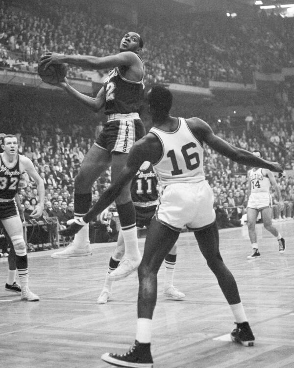 Los Angeles Lakers' Elgin Baylor drives against the Boston Celtics during the NBA championship game April 19, 1962, in Boston.  (AP)