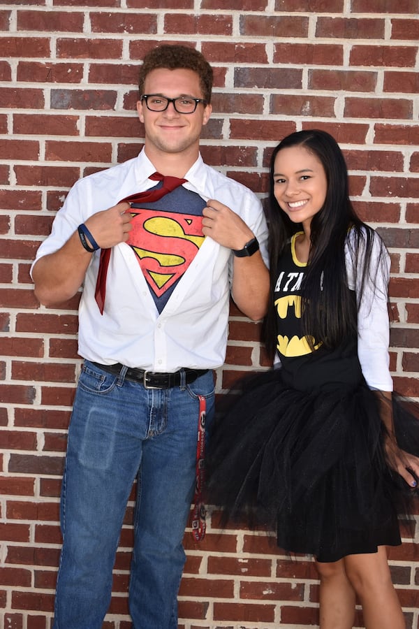 Jeremy and Alyssa Labonte smile for a photo while dressed in superhero outfits at King's Way Christian School.