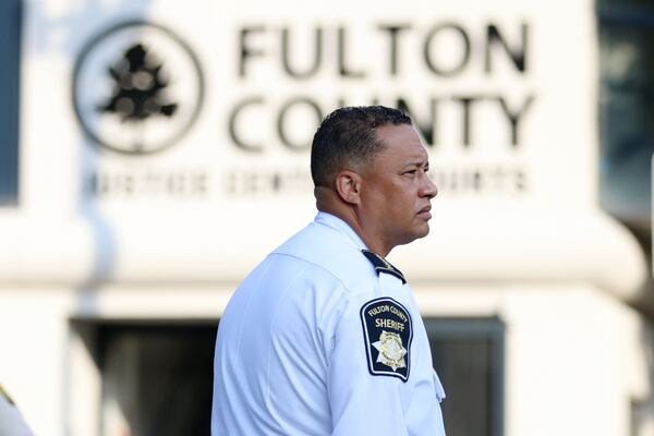 Fulton County Sherrif Patrick Labat looks over the street outside the Fulton County Court during the selection of the special grand jury to investigate allegations that former President Donald Trump criminally interfered with Georgia’s elections in 2020. Monday, May 2, 2022. Miguel Martinez /miguel.martinezjimenez@ajc.com