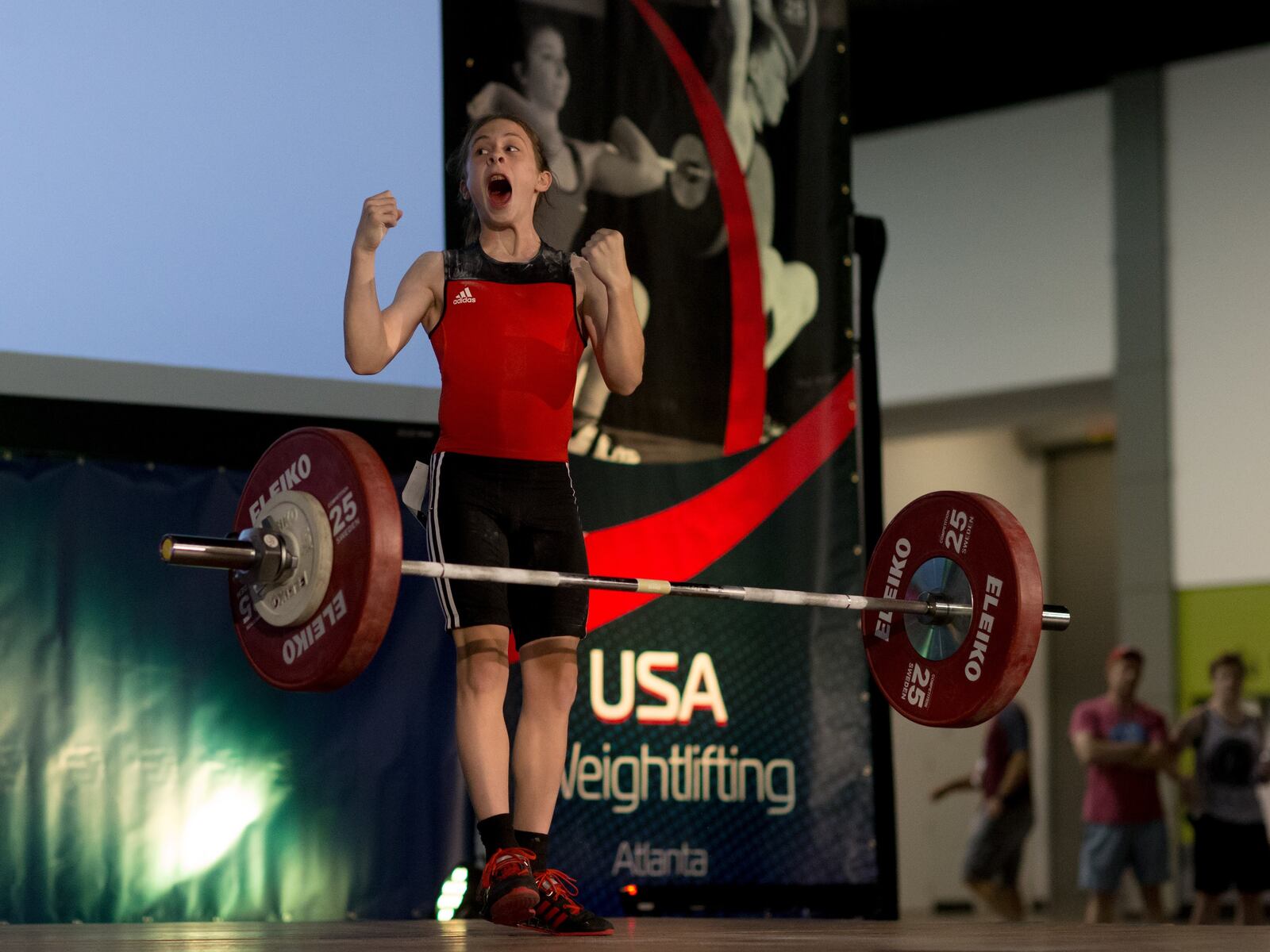 A much younger Hampton Morris successfully completes a lift in competition earlier in his life. Now he owns an Olympic medal.