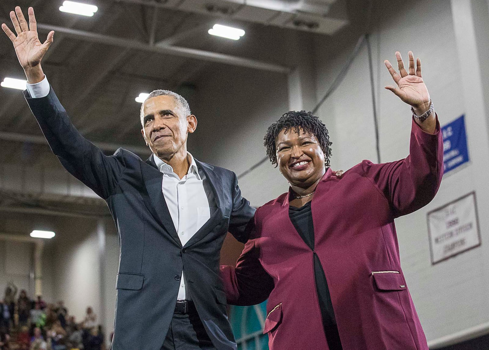 11/02/2018 -- Atlanta, Georgia -- Former President Barack Obama and Georgia gubernatorial candidate Stacey Abrams wave to the crowd following a rally in Forbes Arena at Morehouse College, Friday, November 2, 2018.  (Alyssa Pointer/AJC)