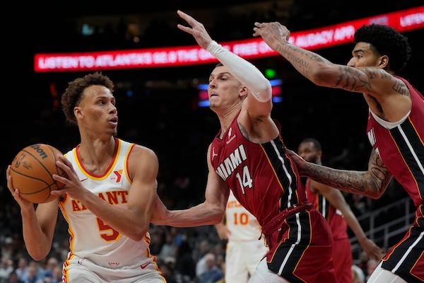 Atlanta Hawks guard Dyson Daniels (5) shoots against Miami Heat guard Tyler Herro (14) during the first half of an NBA basketball game, Monday, Feb. 24, 2025, in Atlanta. (AP Photo/Mike Stewart)