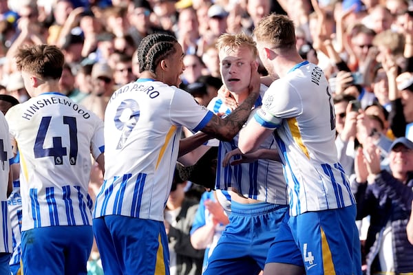 Brighton and Hove Albion's Jan Paul van Hecke celebrates scoring his side's first goal of the game with teammates, during the English Premier League soccer match between Brighton and Hove Albion and Fulham, at the American Express Stadium, in Brighton and Hove, England, Saturday March 8, 2025. (Gareth Fuller/PA via AP)