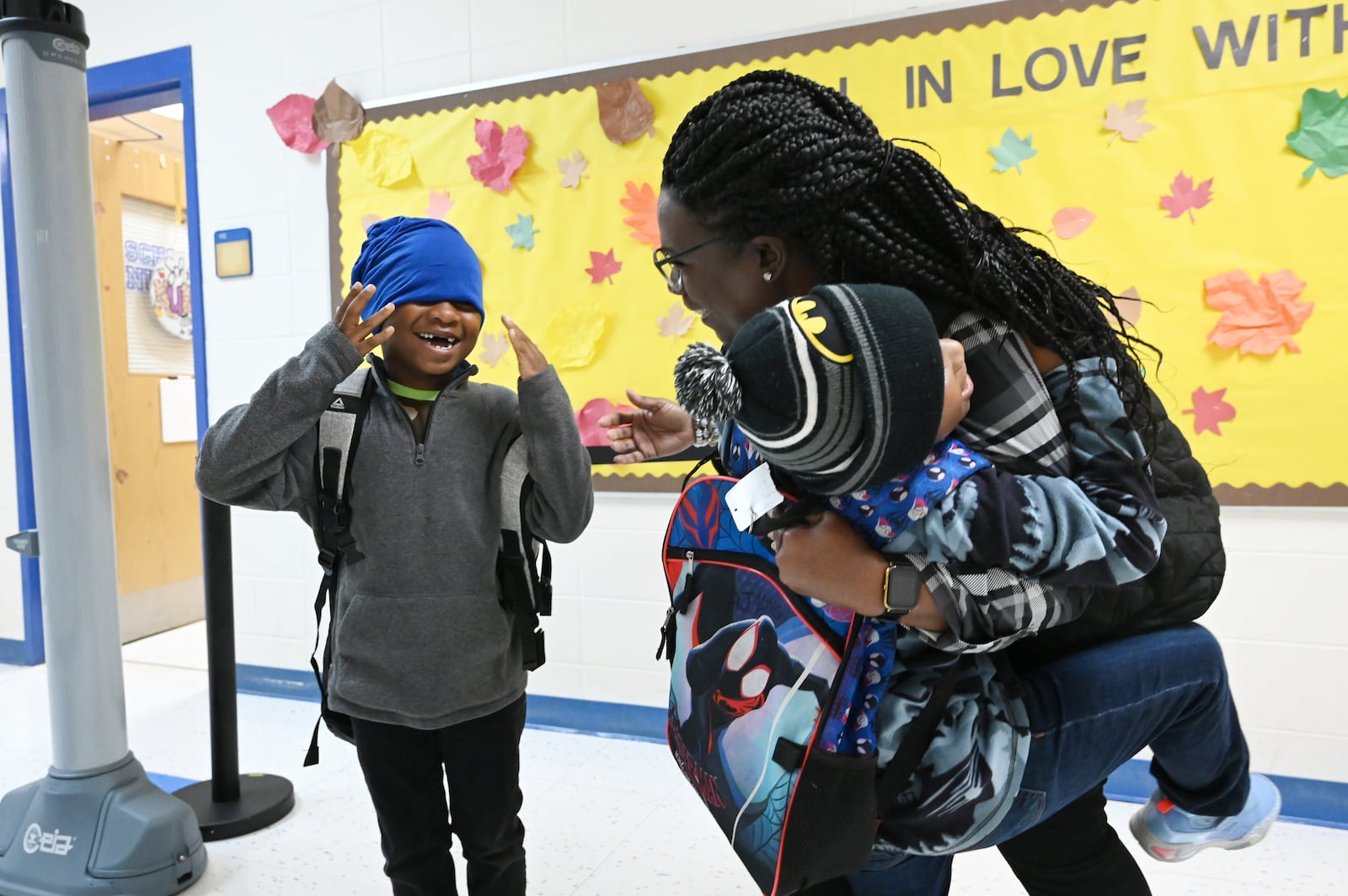 Teacher Shemika Nieves is greeted by students Legend Long (left) and his brother AJ Long as they return to Jeff Davis Primary School in Hazlehurst on Monday, Oct. 21, 2024, for the first time since Hurricane Helene devastated much of South Georgia. (Hyosub Shin/AJC)