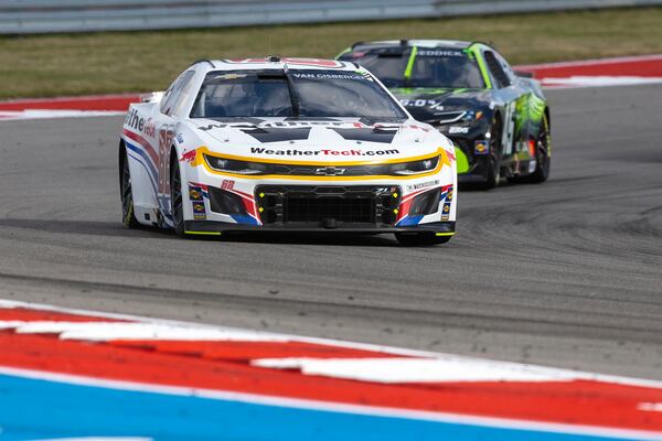 Shane Van Gisbergen, front, pulls through Turn 14 ahead of Tyler Reddick, back, during a NASCAR Cup Series auto race at Circuit of the Americas in Austin, Texas, Sunday, March 2, 2025. (AP Photo/Stephen Spillman)