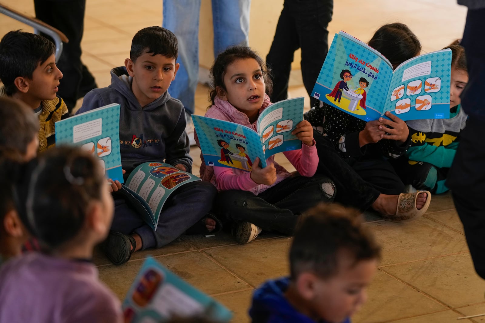 Displaced children, who fled Baalbek city and the nearby towns of Douris and Ain Bourday with their families amid the ongoing Hezbollah-Israel war, study inside at a school being used as a shelter, in Deir Al-Ahmar, east Lebanon, Thursday, Oct. 31, 2024. (AP Photo/Hassan Ammar)