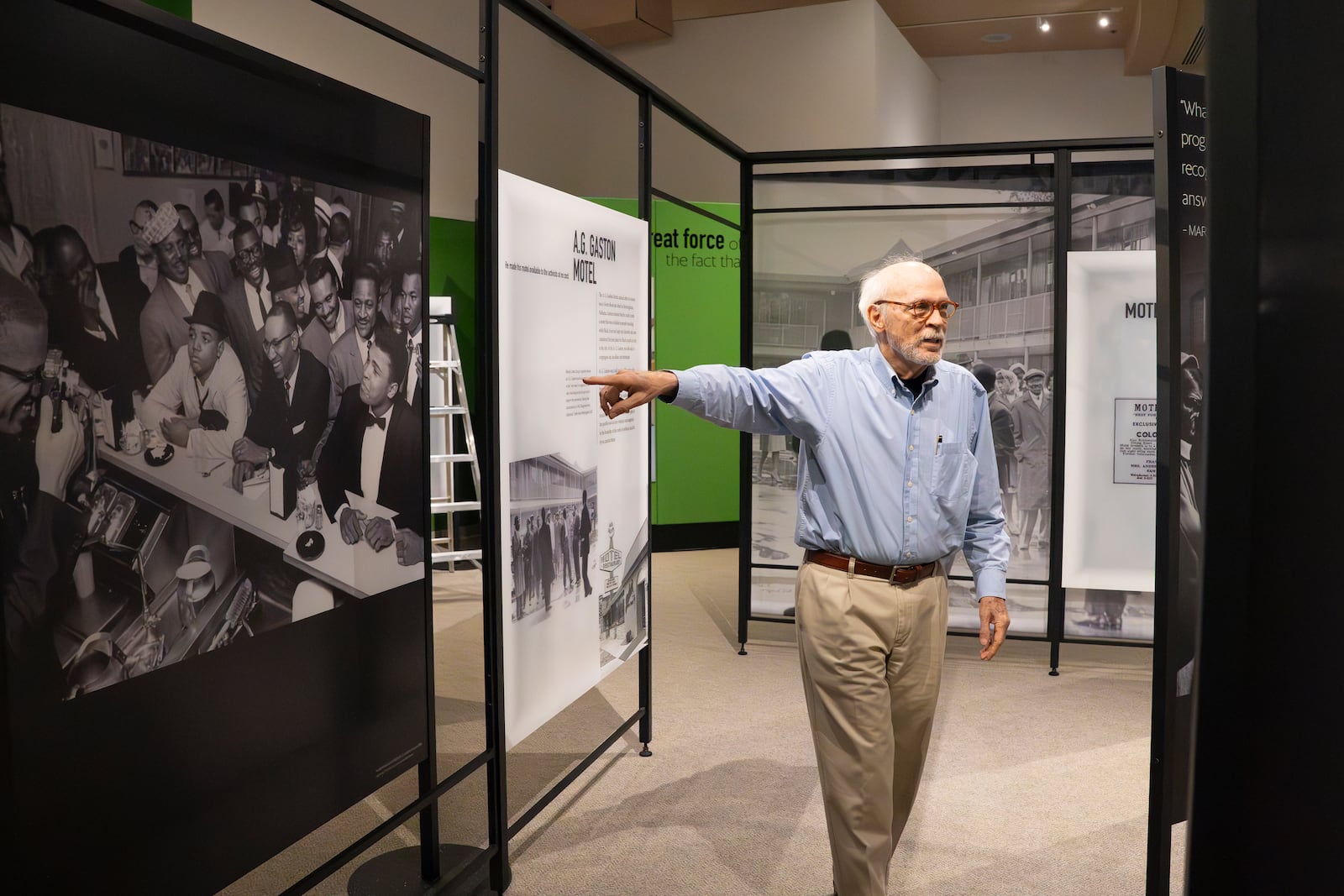 Tony Clark, director of public affairs public affairs director at the Jimmy Carter Presidential Library and Museum points to a historic photo in the Greenbook exhibit, which opened in March.