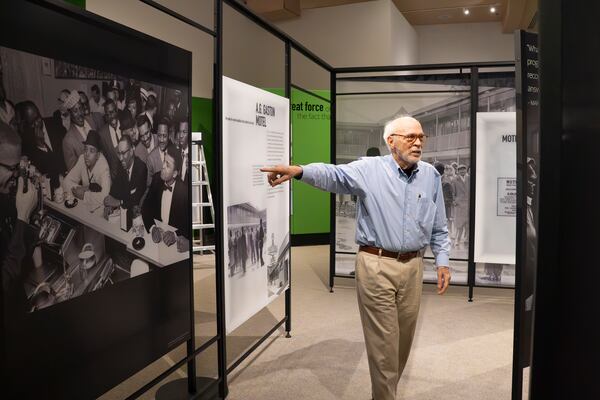 Tony Clark, director of public affairs public affairs director at the Jimmy Carter Presidential Library and Museum points to a historic photo in the Greenbook exhibit, which opened in March.