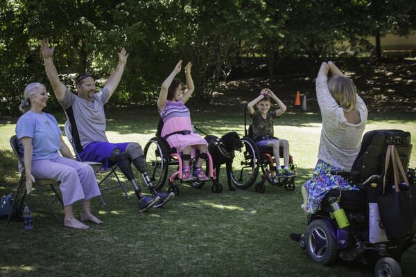 Aimee Copeland, who recently founded the Aimee Copeland Foundation to help others with disabilities, meets with individuals with disabilities at the Chattahoochee Nature Center, where she introduced them to adaptive stretches and exercises they can use at home. CONTRIBUTED