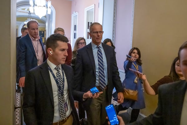 Senate Majority Leader Sen. John Thune, R-S.D., walks from the Senate chamber as the Senate works to avert a partial government shutdown ahead of the midnight deadline, at the Capitol in Washington, Friday, March 14, 2025. (AP Photo/Ben Curtis)