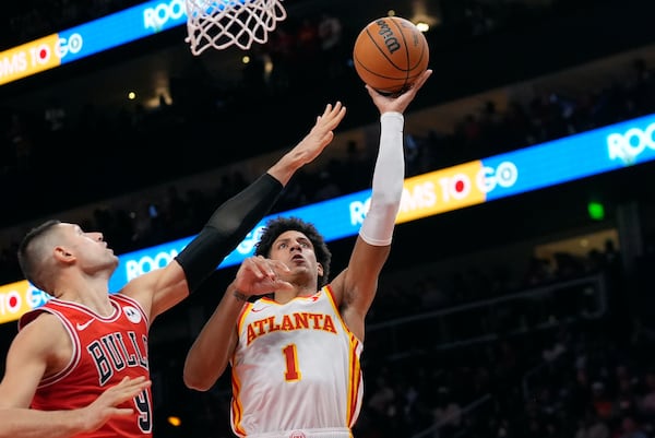 Atlanta Hawks forward Jalen Johnson (1) shoots as Chicago Bulls center Nikola Vucevic (9) defends during the second half of an NBA basketball game Saturday, Nov. 9, 2024, in Atlanta. (AP Photo/John Bazemore)