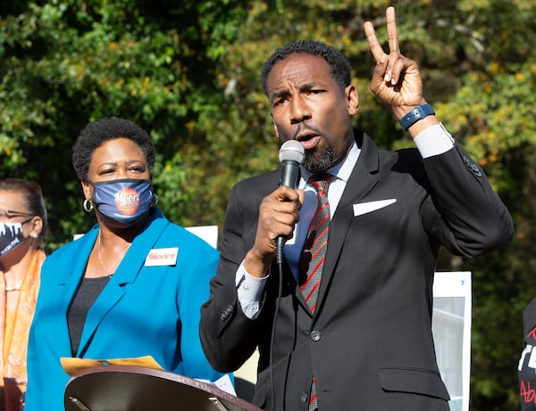 Feilcia Moore listens as Andre Dickens speaks during a rally in Peoplestown last week. PHIL SKINNER FOR THE ATANTA JOURNAL-CONSTITUTION