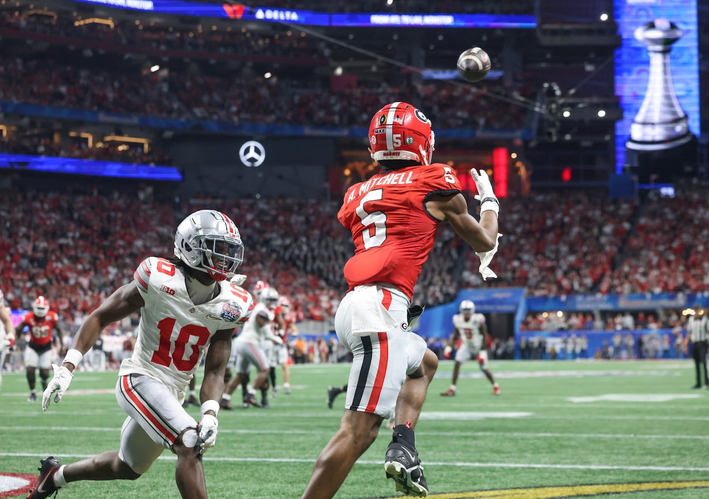 Georgia Bulldogs wide receiver Adonai Mitchell (5) makes a touchdown catch to take the lead after the PAT kick during the fourth quarter of the College Football Playoff Semifinal between the Georgia Bulldogs and the Ohio State Buckeyes at the Chick-fil-A Peach Bowl In Atlanta on Saturday, Dec. 31, 2022.  Georgia won, 42-41. (Jason Getz / Jason.Getz@ajc.com)