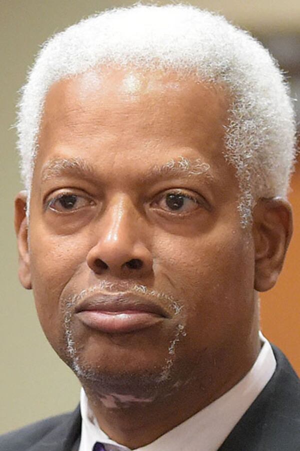 JULY 20, 2015 DECATUR Incoming DeKalb Commissioner Mereda Davis Johnson stands with her husband, US Rep. Hank Johnson,  as she is sworn in by DeKalb Superior Court Judge Gregory A. Adams, Monday, July 20, 2015. Her election brings the county commission to a full seven members for the first time in more than two years. 
KENT D. JOHNSON /KDJOHNSON@AJC.COM