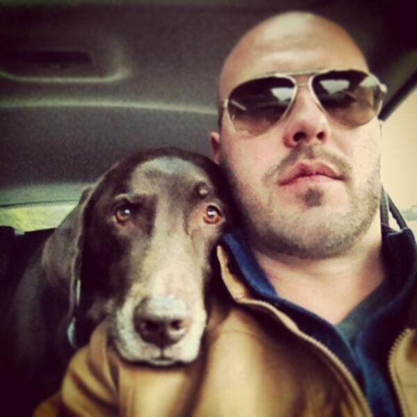 Chris Olinger joined forces with his chocolate lab, Gwen, during a rescue mission at a hoarder's house in Ohio. Photo: Chris Olinger